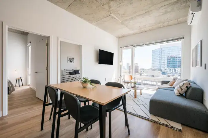Modern apartment interior featuring a dining area and a cozy living space at Post Chicago Apartments, Lincoln Park furnished apartments.