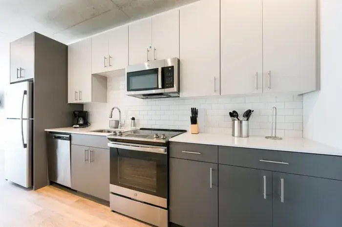 Modern kitchen featuring stainless steel appliances at Post Chicago Apartments, Lincoln Park furnished apartments.