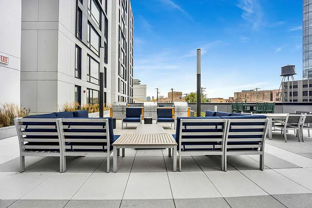 Rooftop lounge area featuring modern outdoor furniture at Post Chicago Apartments.
