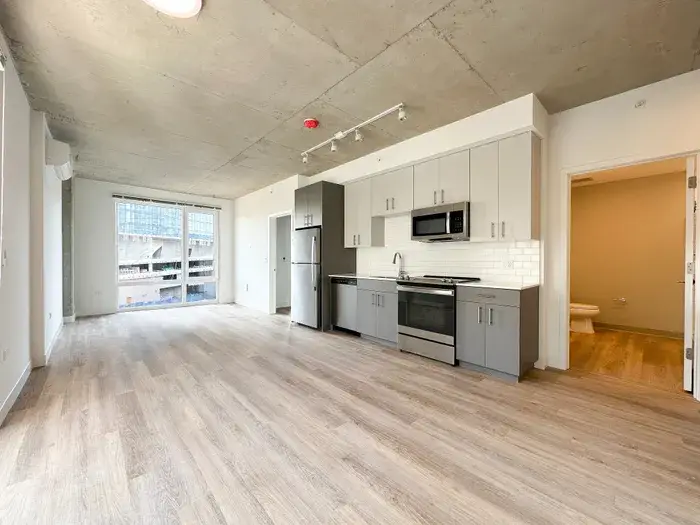 Modern open-concept kitchen and living area at Post Chicago Apartments, Lincoln Park furnished apartments.