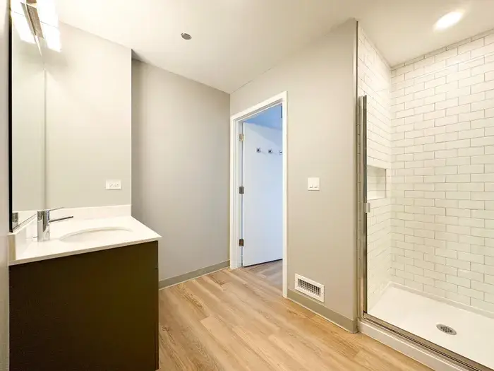 Modern bathroom featuring a sleek vanity with a mirror at Post Chicago Apartments, Lincoln Park furnished apartments.